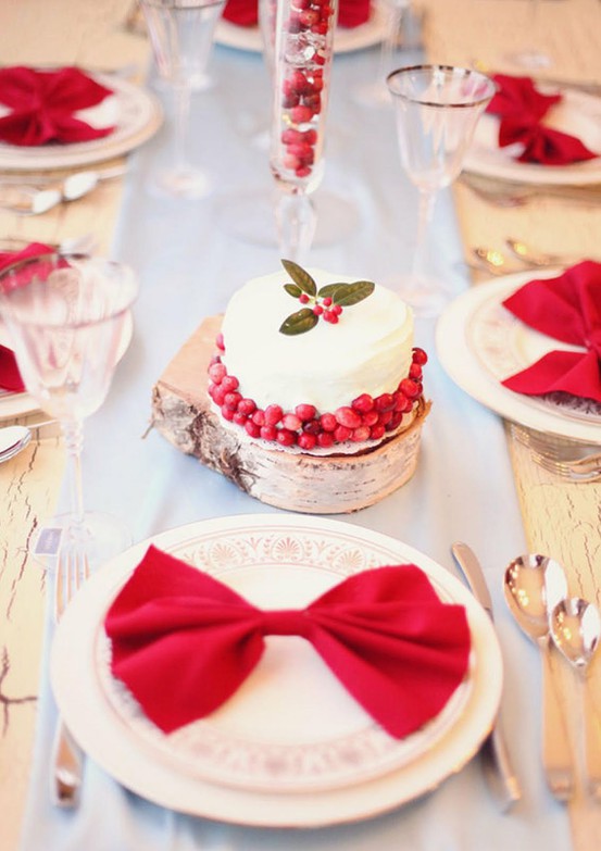 Sweetly vibrant, warm, beautiful Christmas table setting with bows and pomegranate seeds