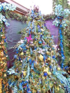 Purple peacock feather and blue butterfly decorated christmas tree